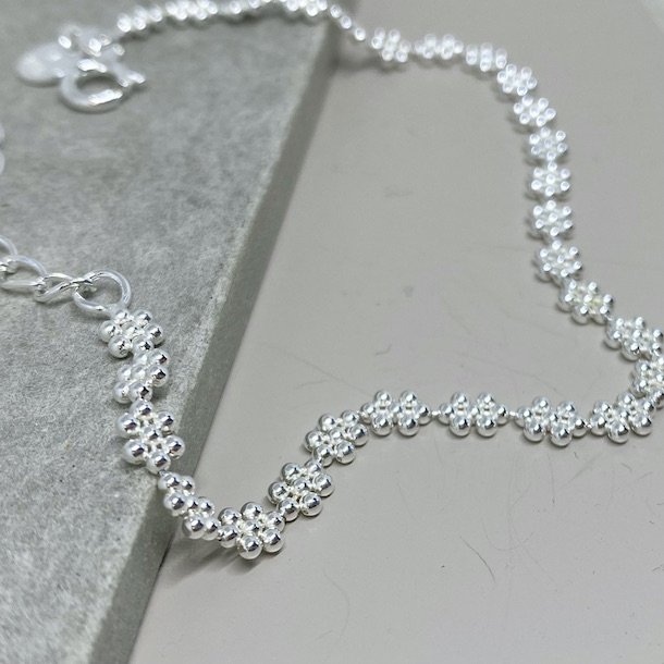 Armbnd LOTS OF FLOWERS sterling slv